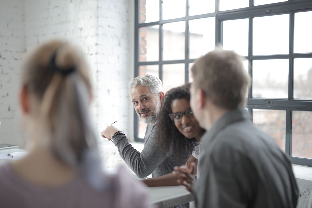 A diverse team of professionals in conversation around a table