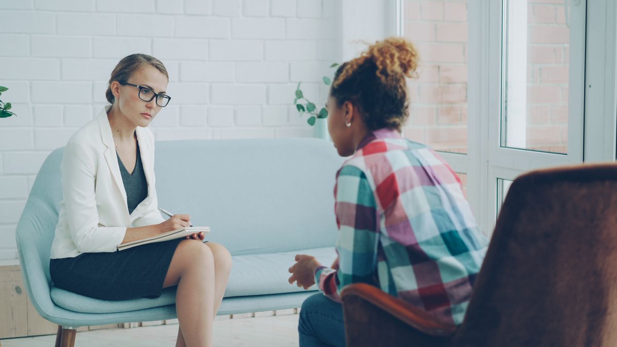 A therapist listening attentively to a client during a counseling session
