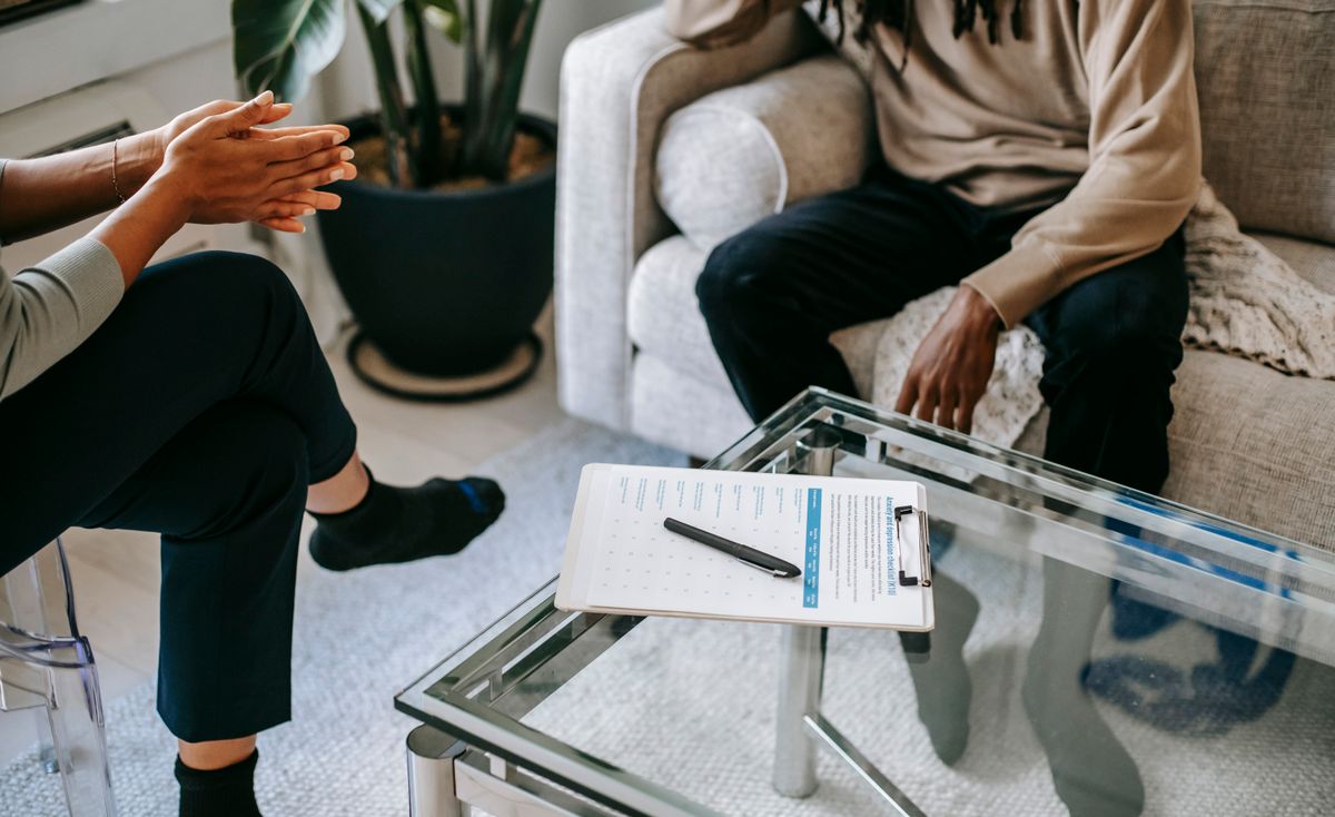 A clinician and client talking during an outpatient assessment session