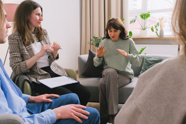 A small group talking together during a guided group therapy session