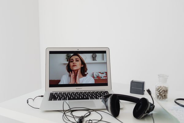 A laptop showing a therapist during a secure telehealth session